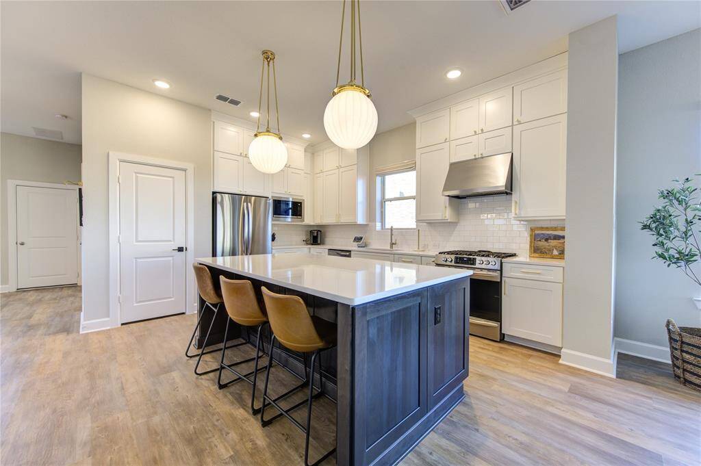 Expansive quartz countertops provide a durable and luxurious workspace, perfect for meal prep and hosting.