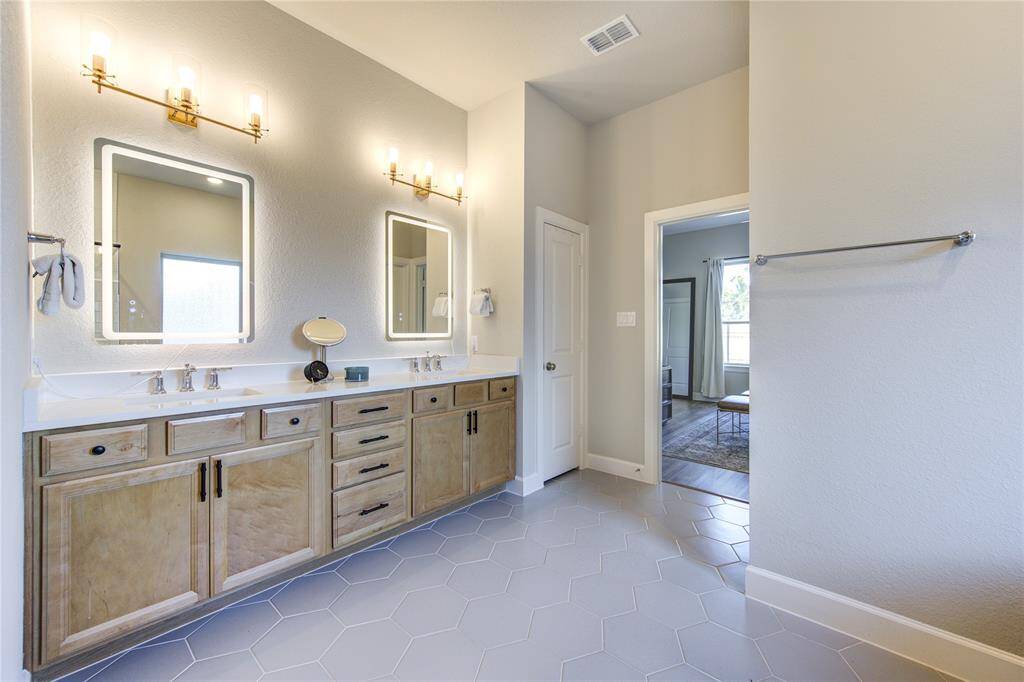 The details in this home are so high end and on-trend, including this natural wood vanity in the primary bathroom.