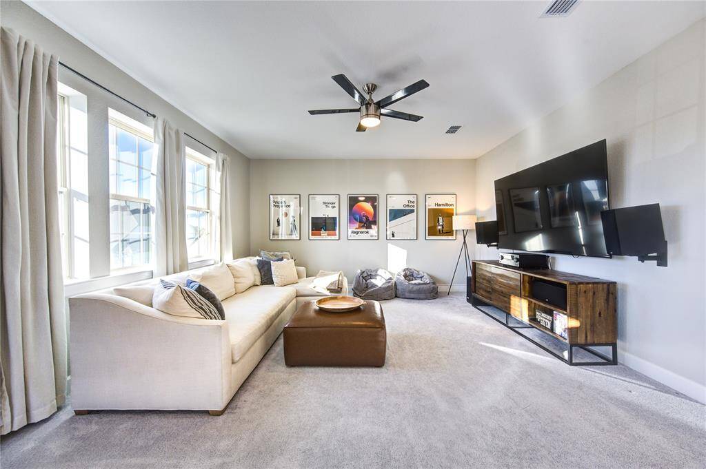 A spacious upstairs game room offers the perfect area for entertainment, play, or media.