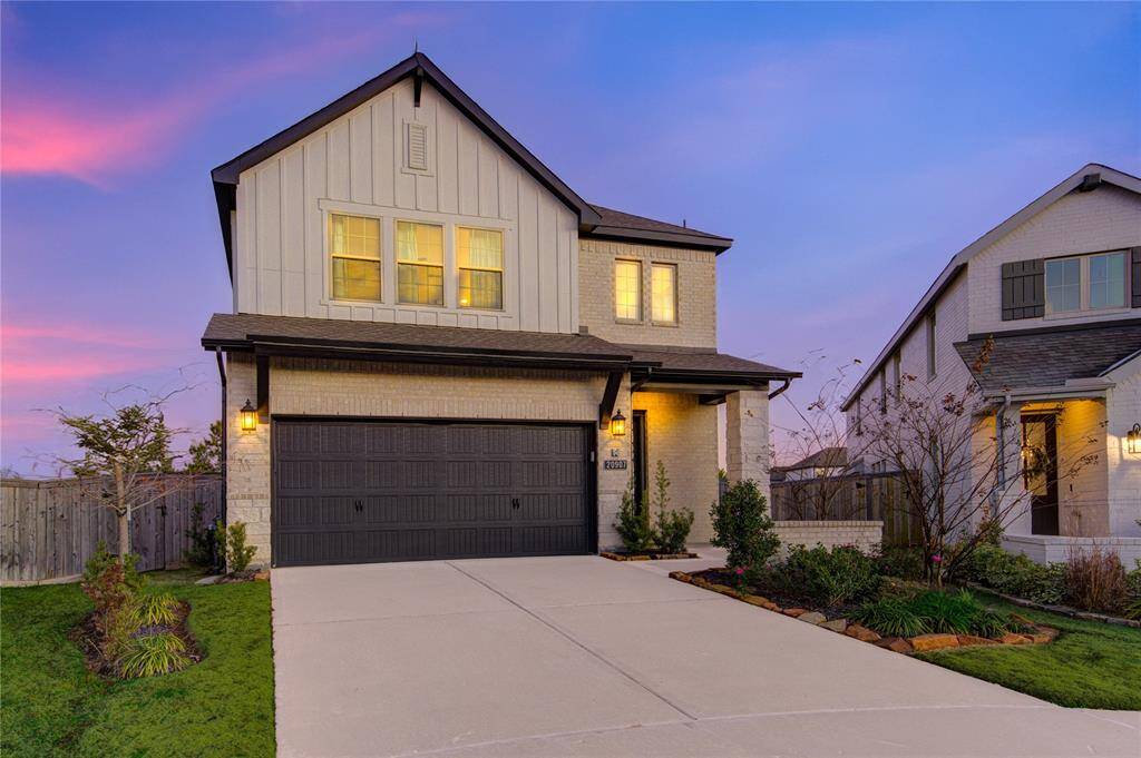 A spacious driveway provides ample parking, and the two-car garage offers additional convenience for homeowners and guests.
