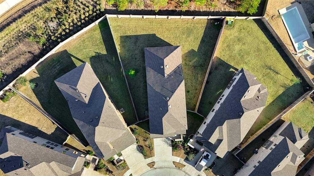 The aerial perspective also captures the scenic green space behind the home, adding to the sense of privacy and tranquility. Whether enjoying the outdoors or envisioning your dream backyard oasis, this property provides an unbeatable combination of space, privacy, and natural beauty.