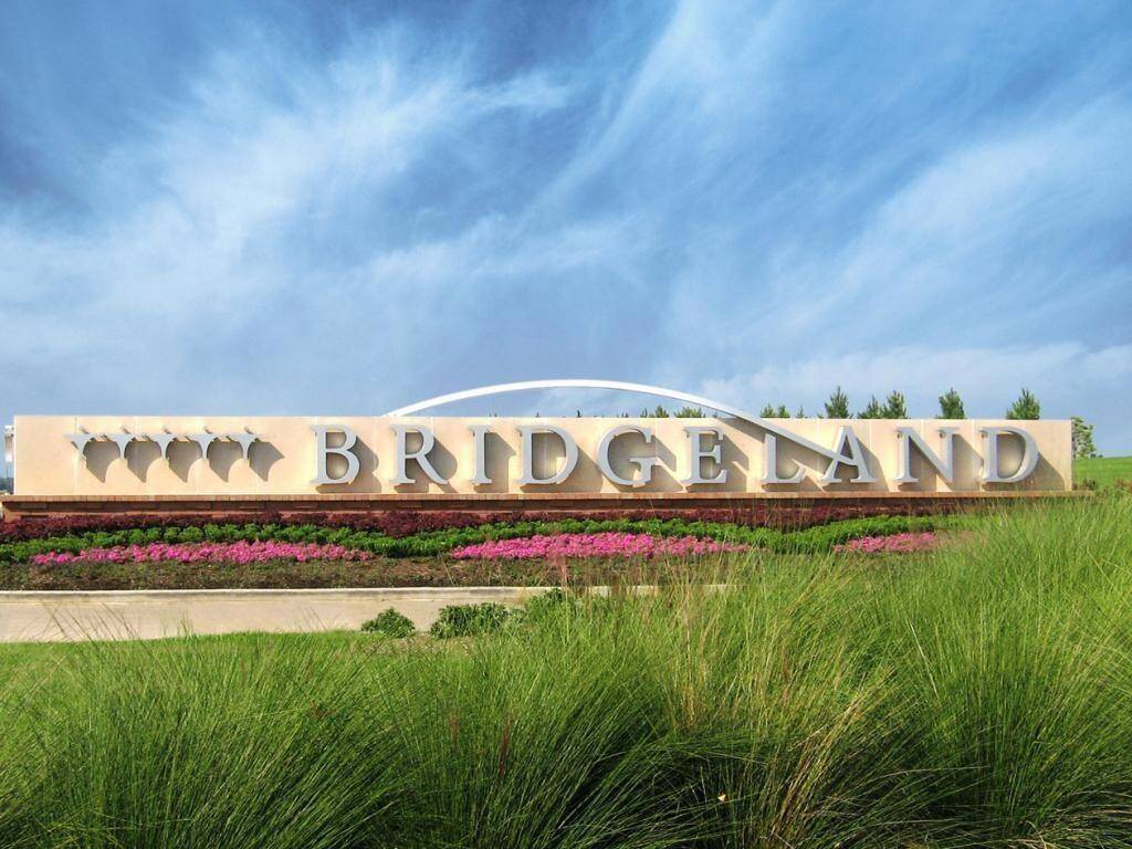 The stunning entrance to Bridgeland welcomes residents with lush landscaping, scenic water features, and beautifully designed signage, setting the tone for this master-planned community.