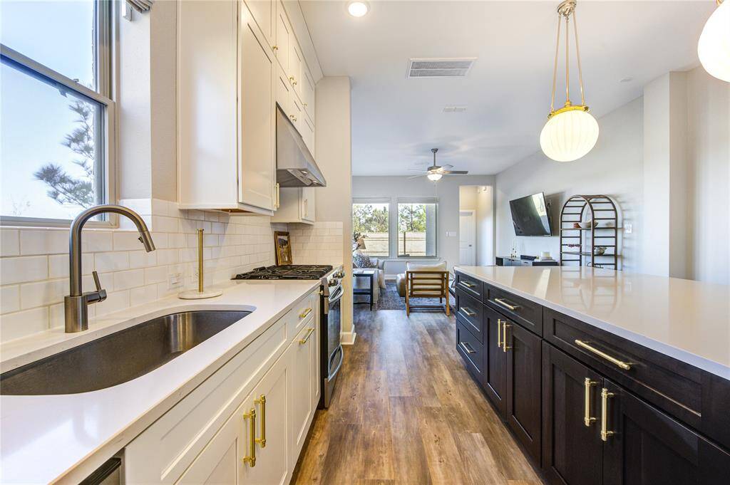 This stunning island kitchen is the heart of the home, designed for both functionality and style with modern upgrades and high-end finishes.