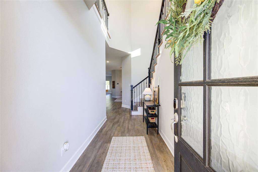 A stylish front door opens to a bright, airy entryway that highlights the home’s modern upgrades and on-trend finishes.