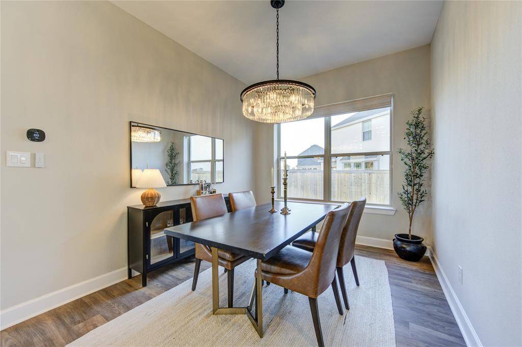 The dining space flows effortlessly from the kitchen, providing the perfect setting for both casual meals and elegant gatherings.