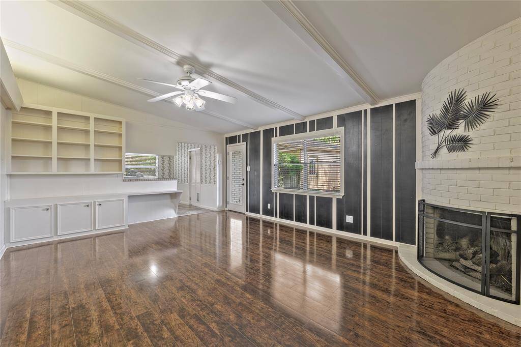 Family Room/Den with builtins and curved fireplace