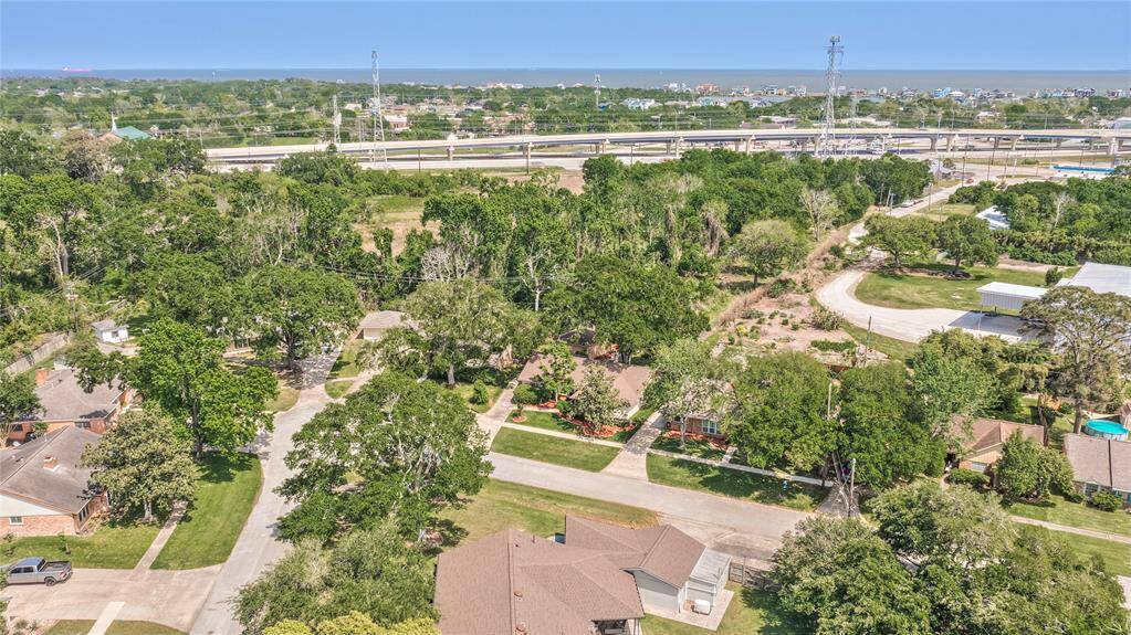 Aerial View of Neighborhood and where home is situated with treed lot behind it