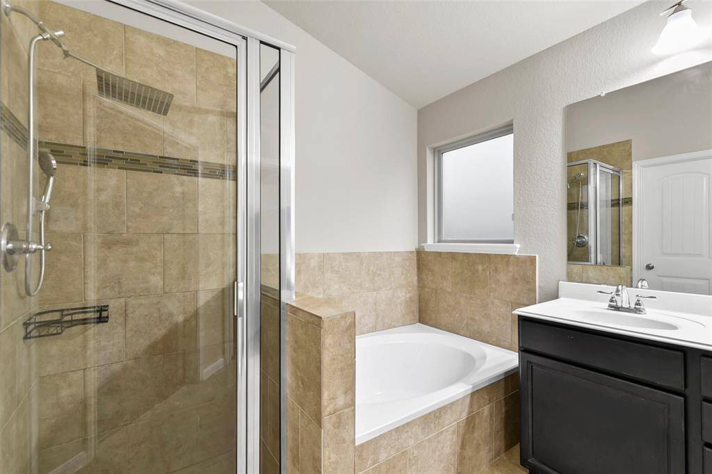 Dual sinks, soaking tub and separate shower in primary bath