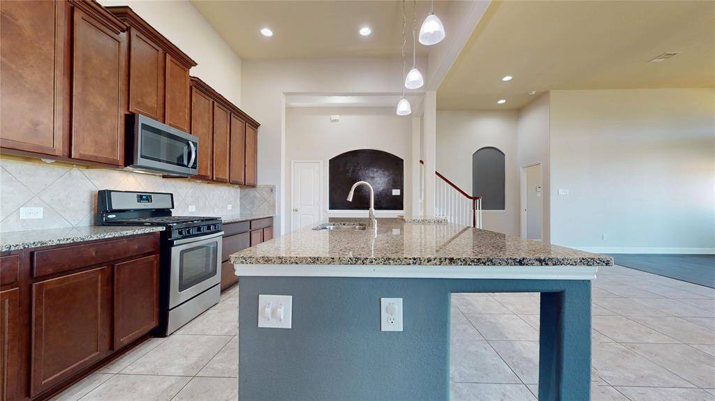 This photo showcases a the modern kitchen with spacious countertops.
