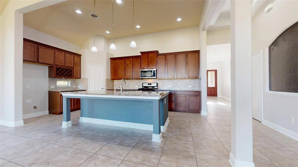 Another look at the kitchen, large kitchen island and breakfast bar.