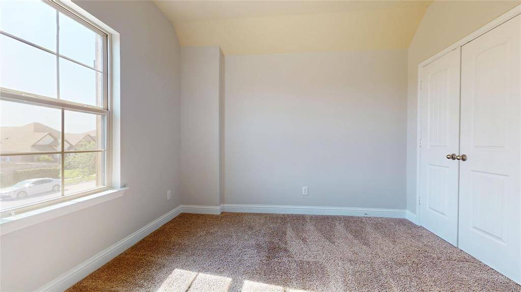Guest Bedroom #4 with a large window and neutral walls.