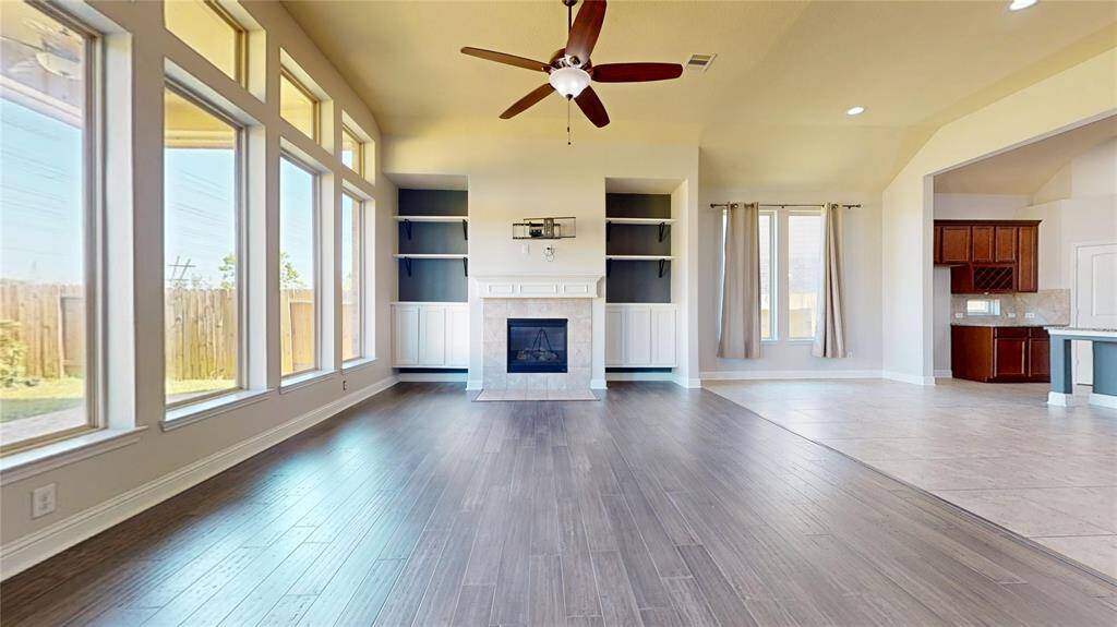 The abundant natrual light throughout the living area flows seamlessly into the adjacent kitchen and dining area, perfect for modern living.