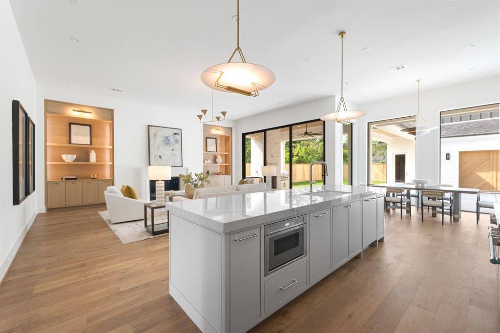 A stunning kitchen bathed in natural light, with large windows allowing sunlight to flood the space.