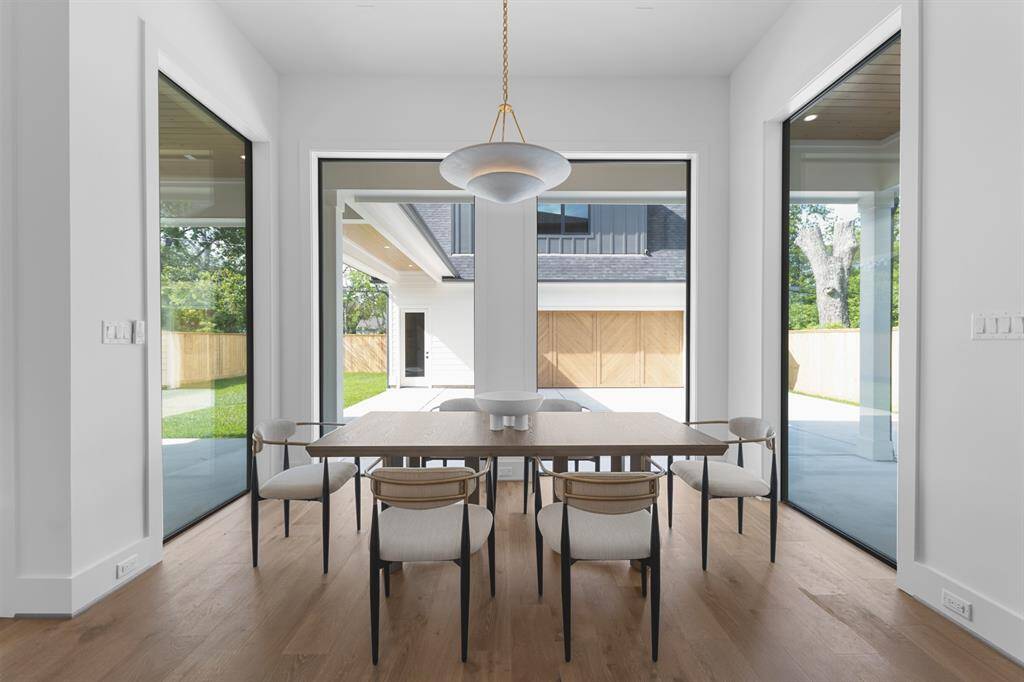 Bathed in natural light from expansive windows, the breakfast area offers a cozy yet refined space for casual dining. Nestled just off the kitchen, it features wide-plank white oak floors and a clean, open layout that invites relaxed mornings and effortless connection.