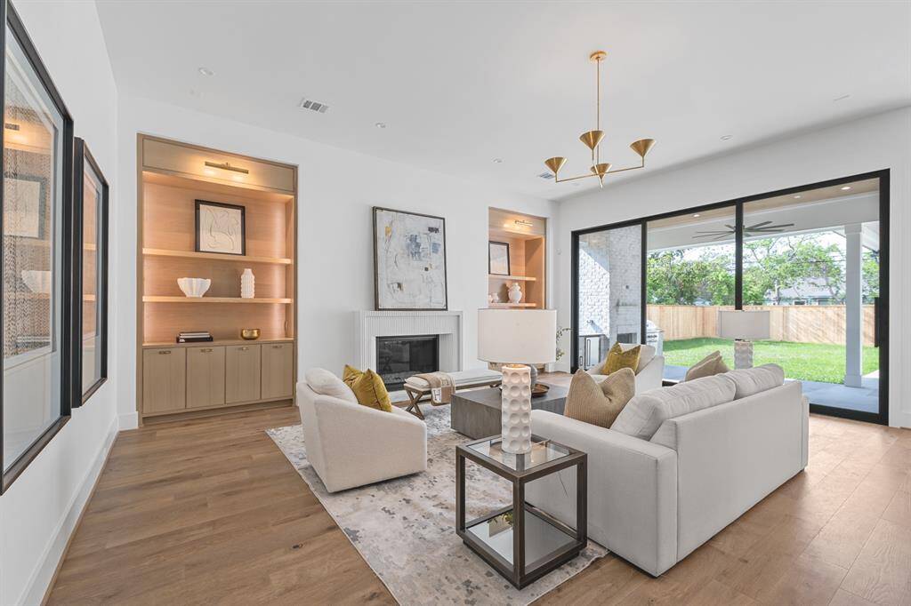 A wide expanse of white oak flooring fills the frame, showcasing its natural grain and light tones. The flooring stretches into a large, open living space, suggesting a modern and airy interior design