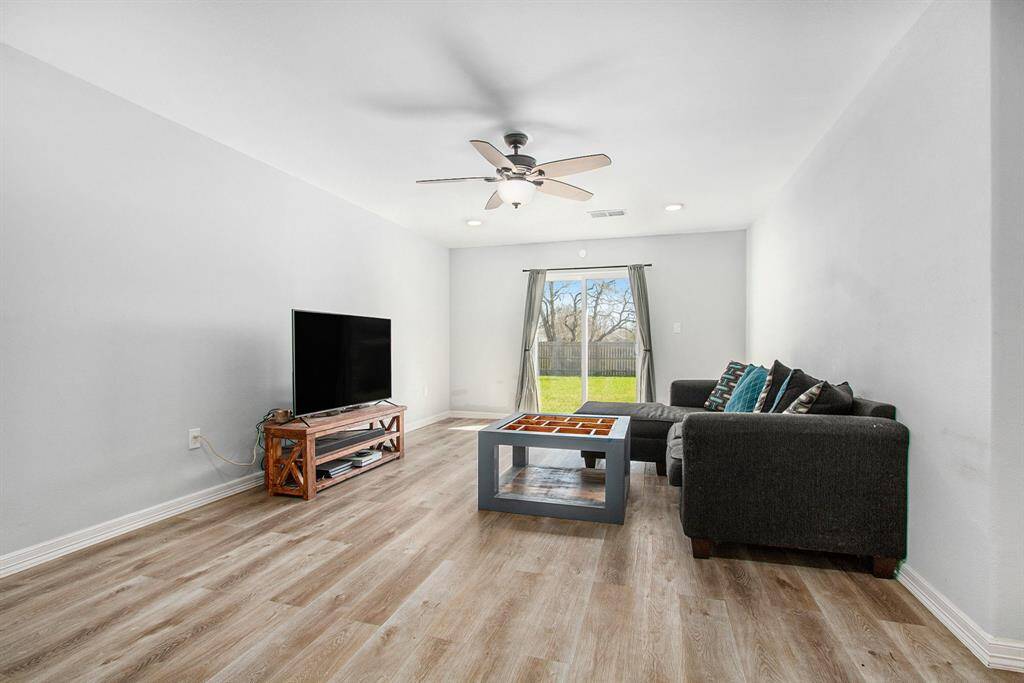 The living room with big sliding glass door to the back yard, offer an abundance of natural light to flood the space.
