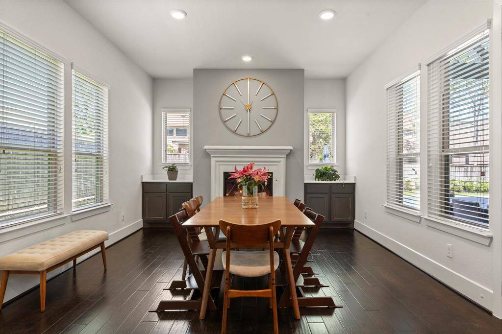 The main dining area is a cozy yet elegant space, featuring a classic fireplace flanked by built-in cabinetry—ideal for intimate dinners or festive gatherings.