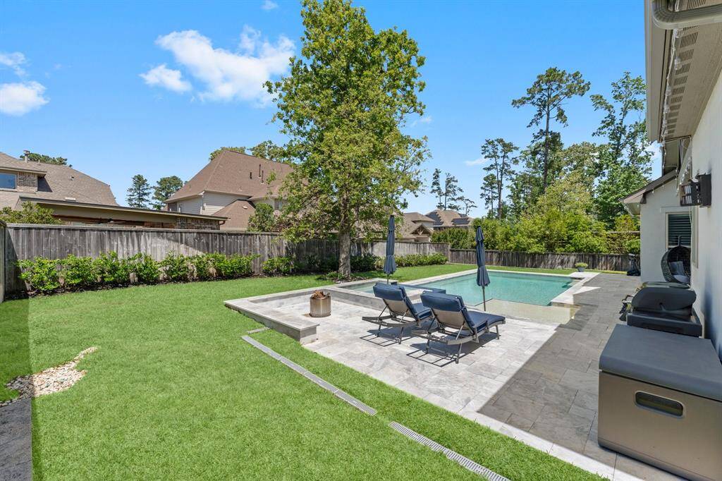Step into your own private resort featuring a sleek modern pool with a sun shelf, built-in umbrella stands, and an elevated spa with cascading water feature—all surrounded by elegant stone decking.  Extensive drains have been to allow rainwater to flow to the street.