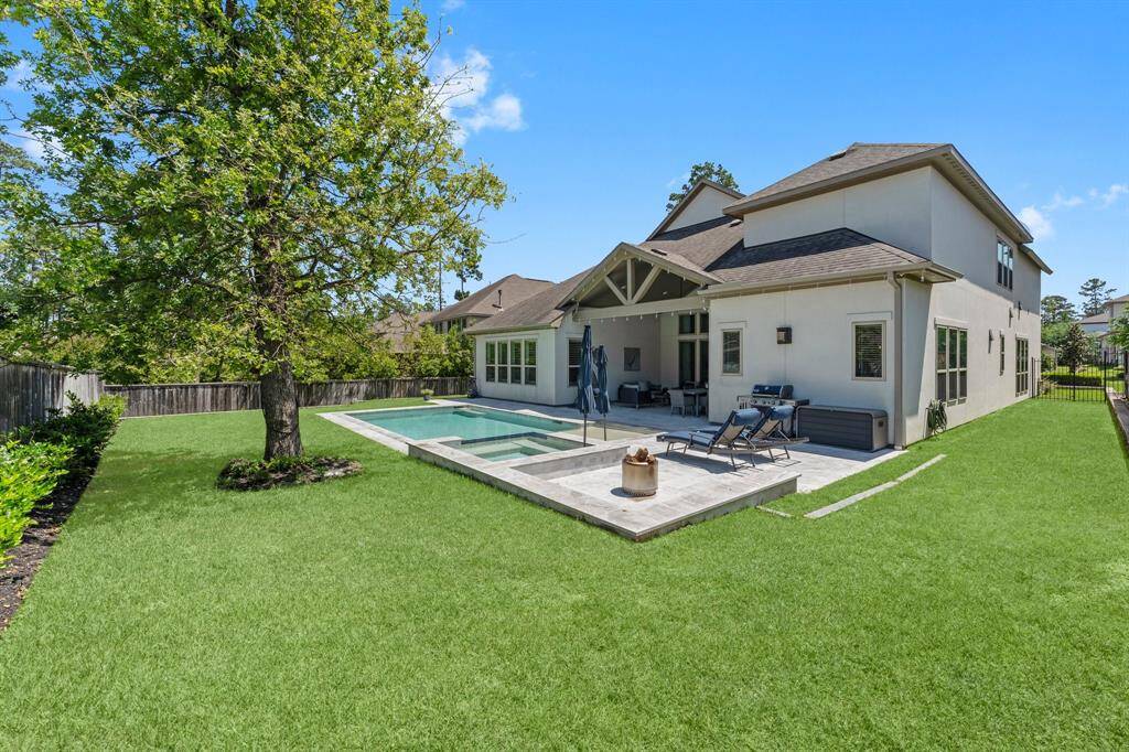 Lush, manicured landscaping and mature tree creates a picturesque backdrop for the spacious backyard, where the pool and lawn effortlessly blend relaxation and recreation.