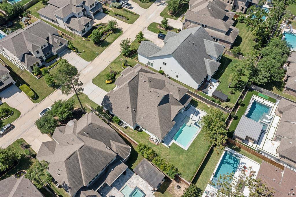 An aerial view reveals the home’s impressive footprint and oversized lot, nestled within a prestigious enclave of luxury properties—just moments from top-rated schools, parks, and premium amenities.