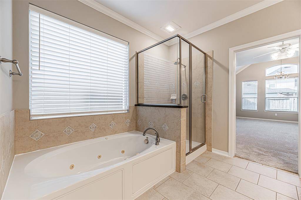 Primary bathroom has a separate glass door walk in shower and soaking tub.