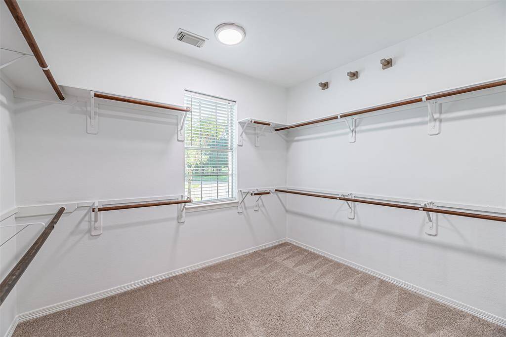 Primary bathroom has a large walk in closet with window and tons of space for all your clothes.