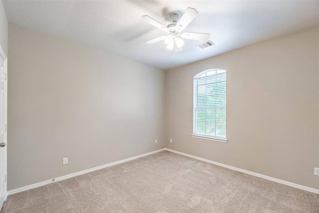 Third bedroom upstairs has carpet, ceiling fan and picture window.