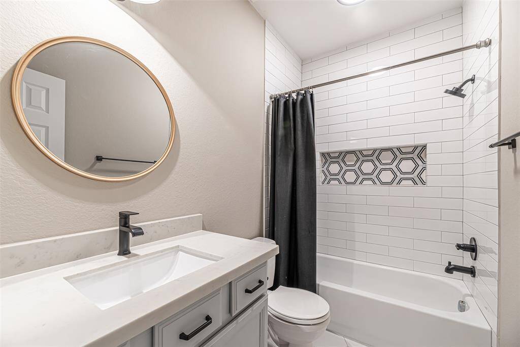 Second full bathroom upstairs has been updated to feature quartz countertops, tub/shower combo with subway tile to ceiling and decorative tile nook.