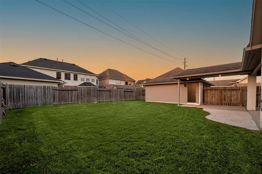 Backyard features an extended patio perfect for entertaining.