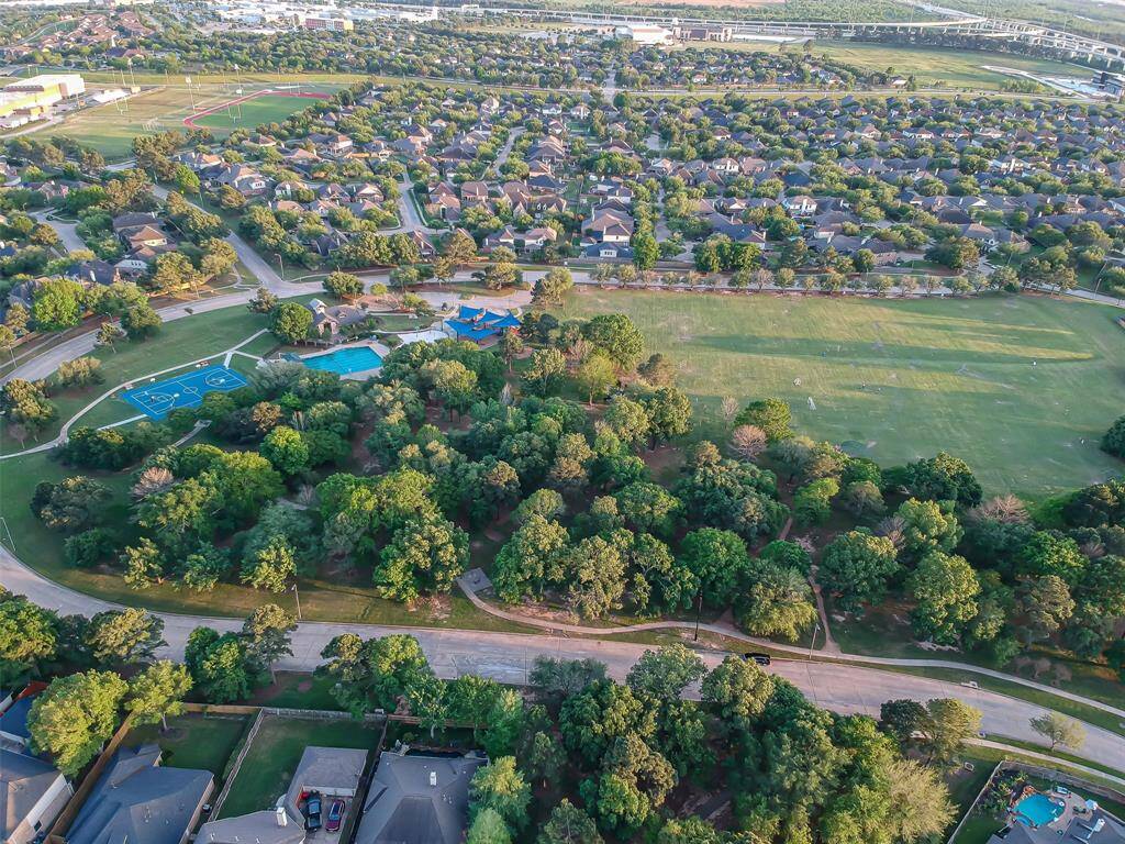 Aerial view of the home showing the location of the pool, tennis courts and other amenities of the neighborhood.