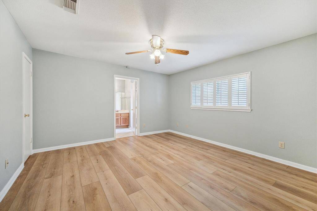 Primary bedroom with laminate flooring