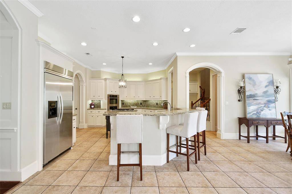 View of the kitchen from the family room showing open concept.