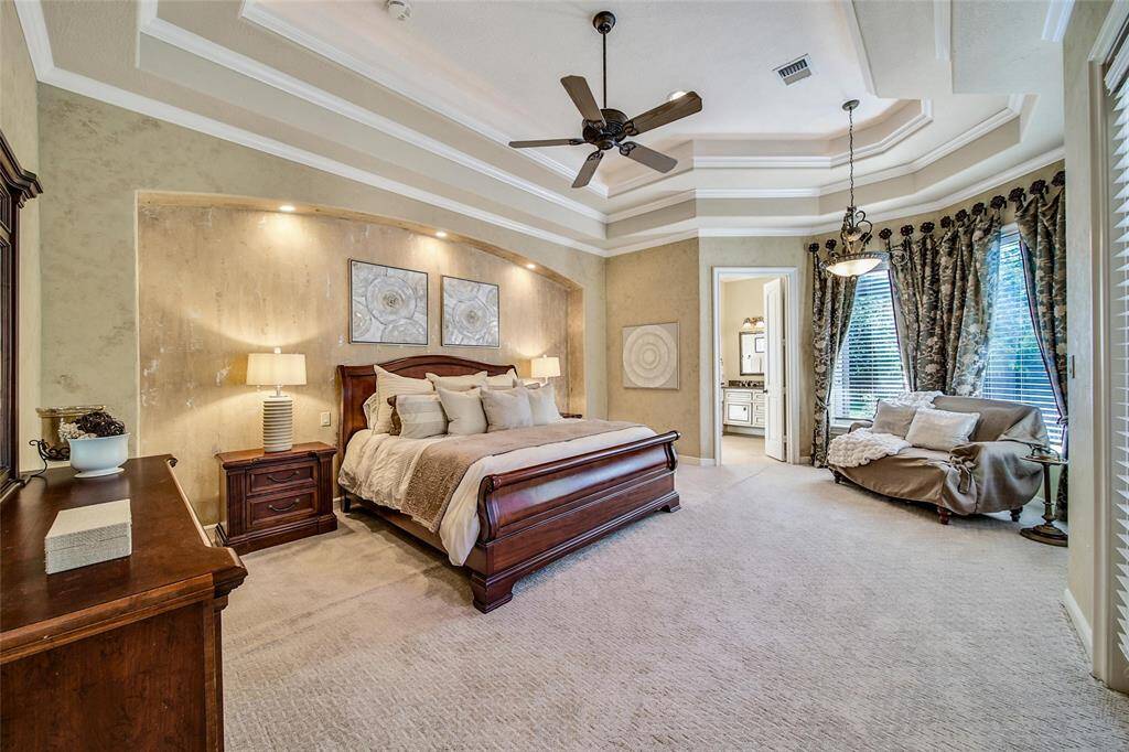 Primary Bedroom, large windows let in so much natural light and show off the stunning backyard.