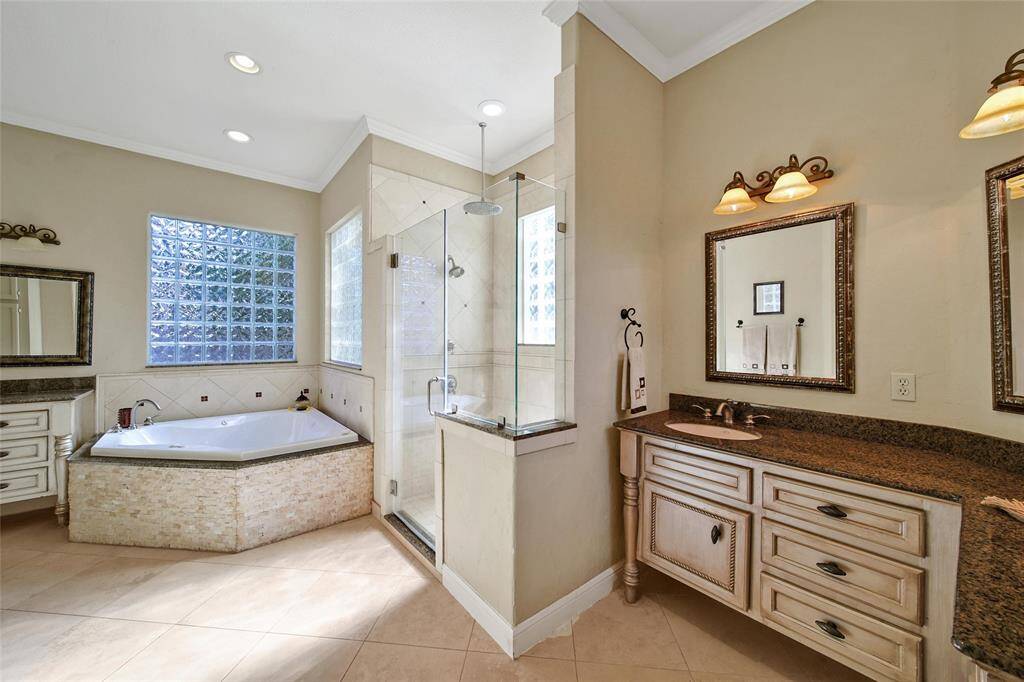 Large soaking tub and separate walk in shower with ample counter space at the two separate sinks.