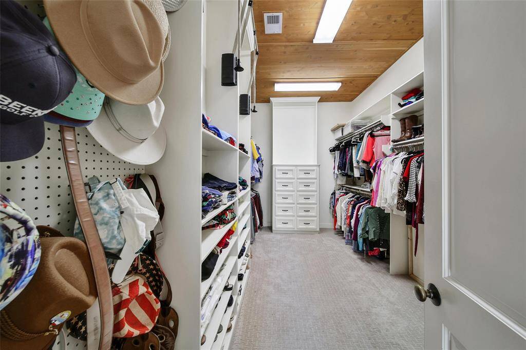 Walk in closet off the primary bath has cedar planks on the ceiling.