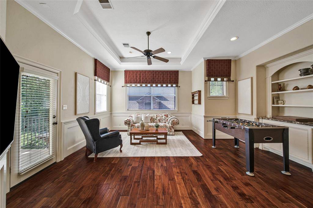 Game room on the second floor with a door to the balcony. Beautiful wood floors throughout.