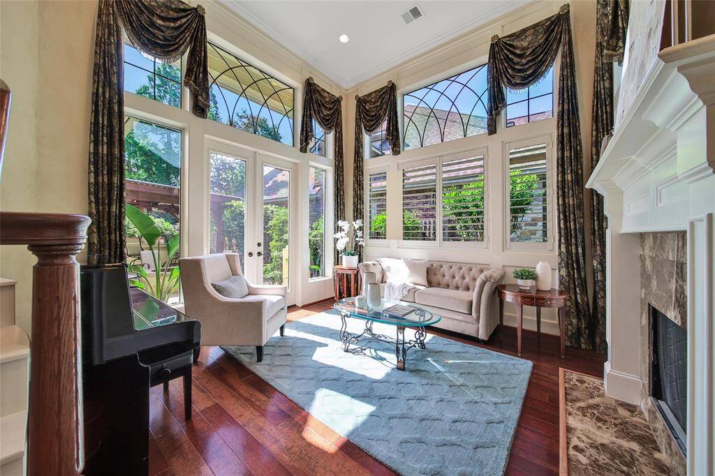 Formal Living opens up to the backyard and gets so much natural light. Very cozy with the fireplace.