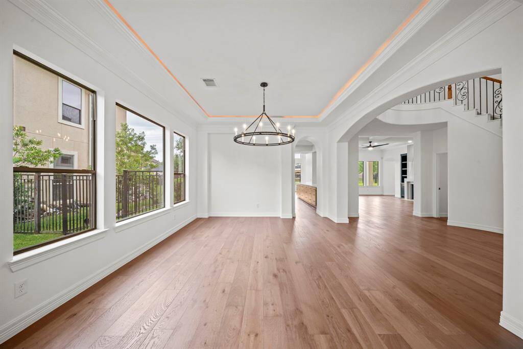 The downstairs has custom wood flooring and large windows throughout