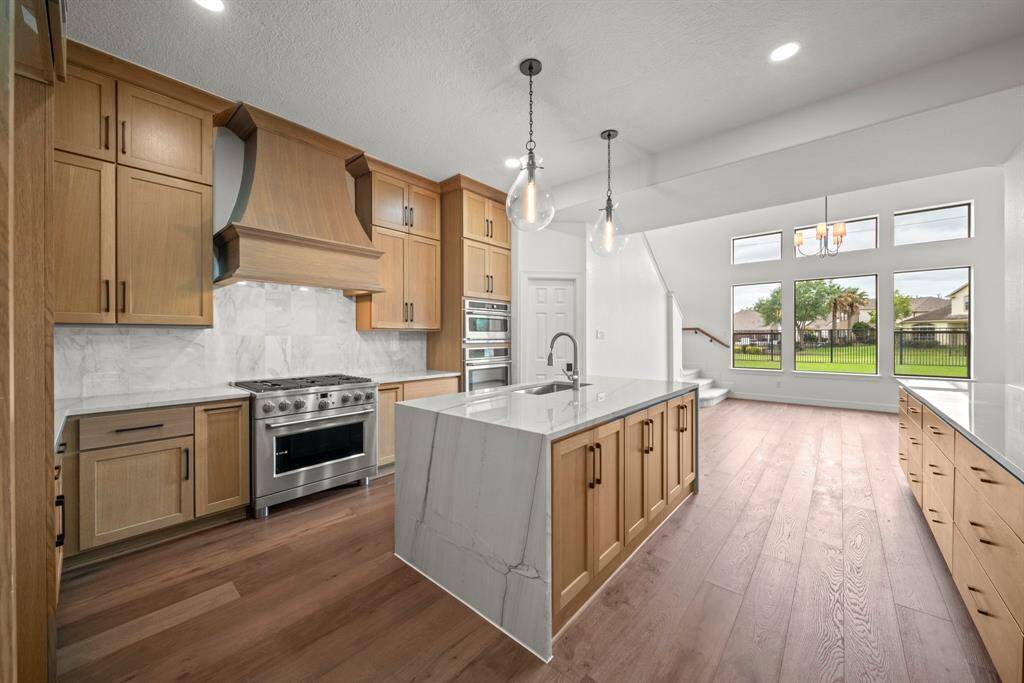 The chefs delight kitchen with 6 burner stove, wine fridge, custom cabinets, large pantry and so much more