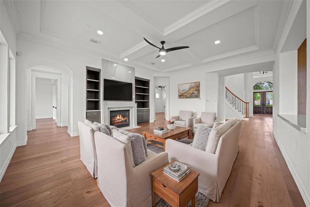 The large open den with gas log fireplace, marble mantle high ceilings