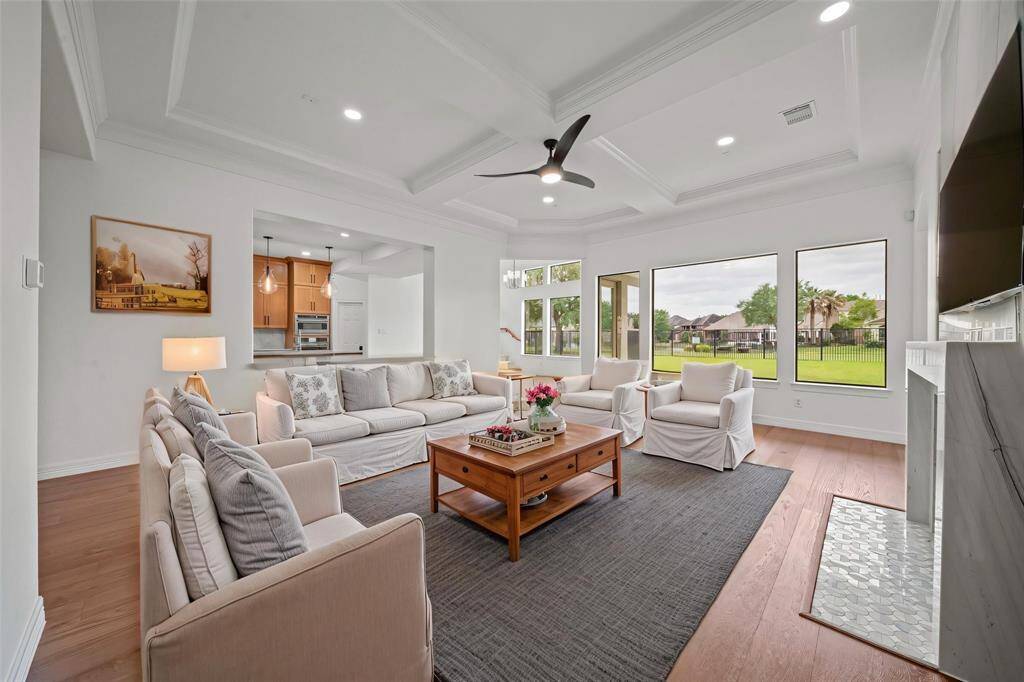Wall of windows in the den overlooks the backyard and waterview