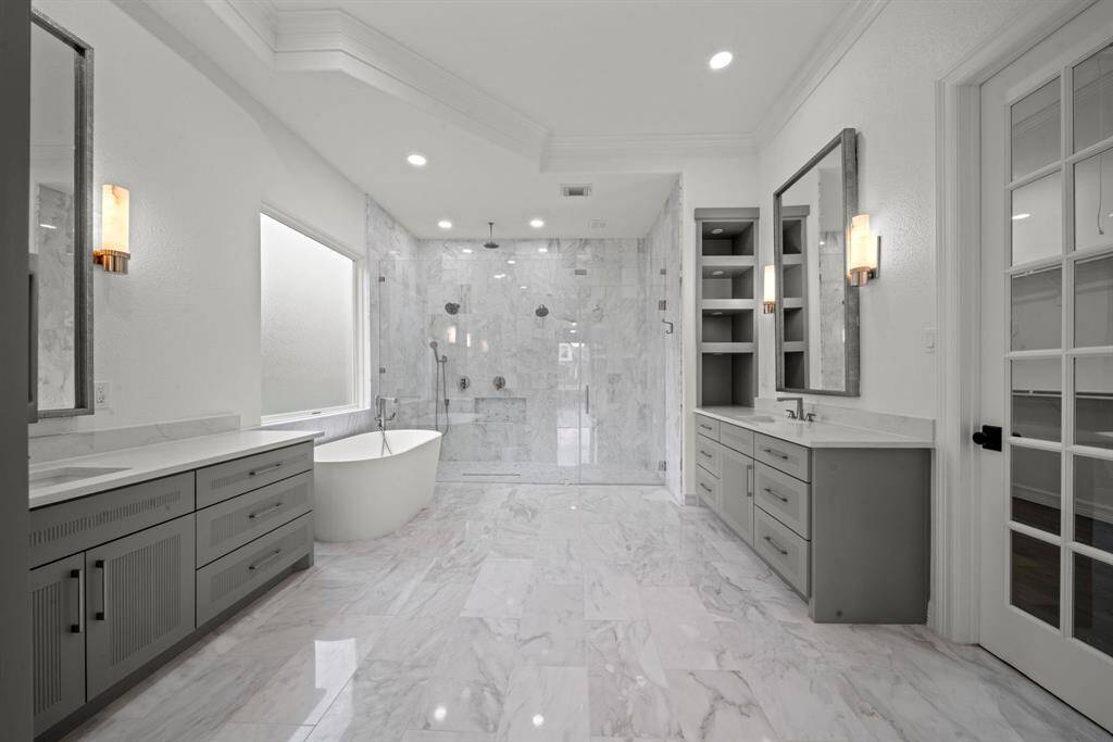 Youll find it easy to relax in this spa like primary bathroom