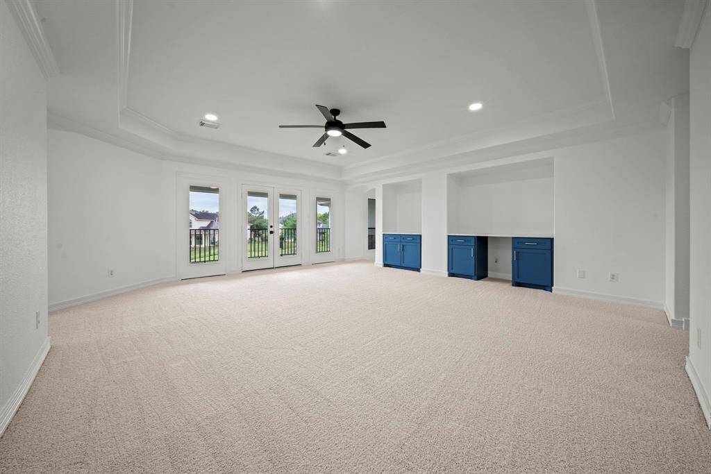 Upstairs the gameroom is large with french doors to the upstairs patio/deck