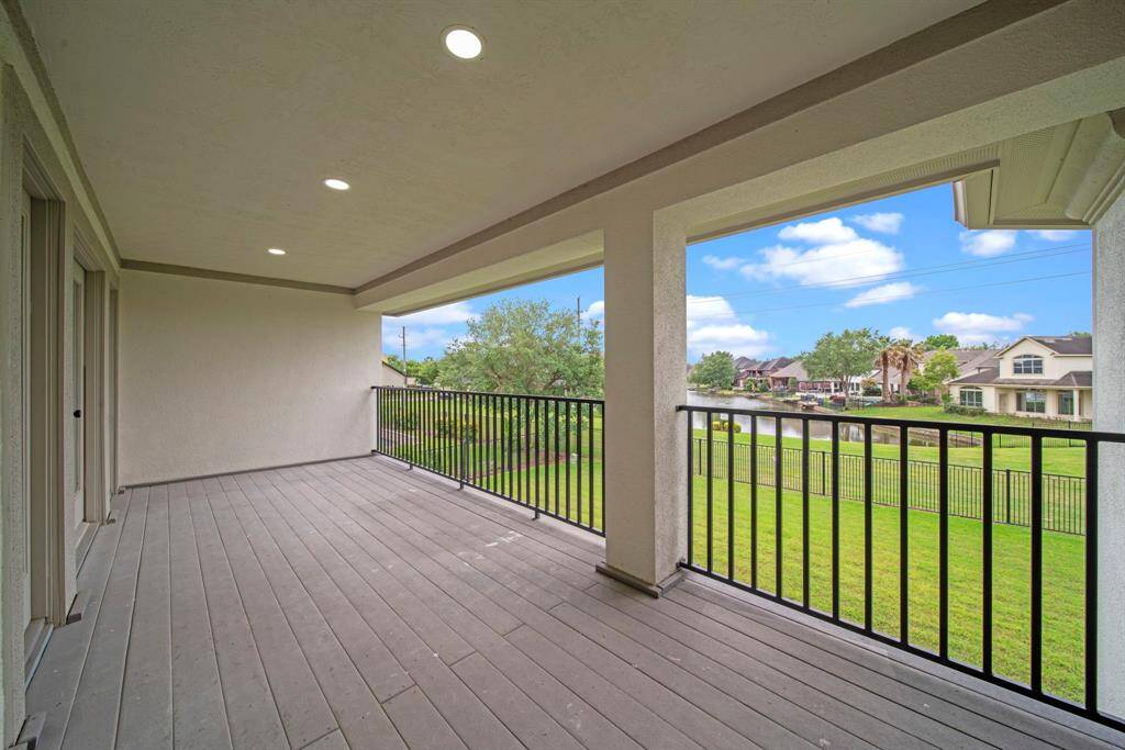 The upstairs deck overlooks the backyard and waterview