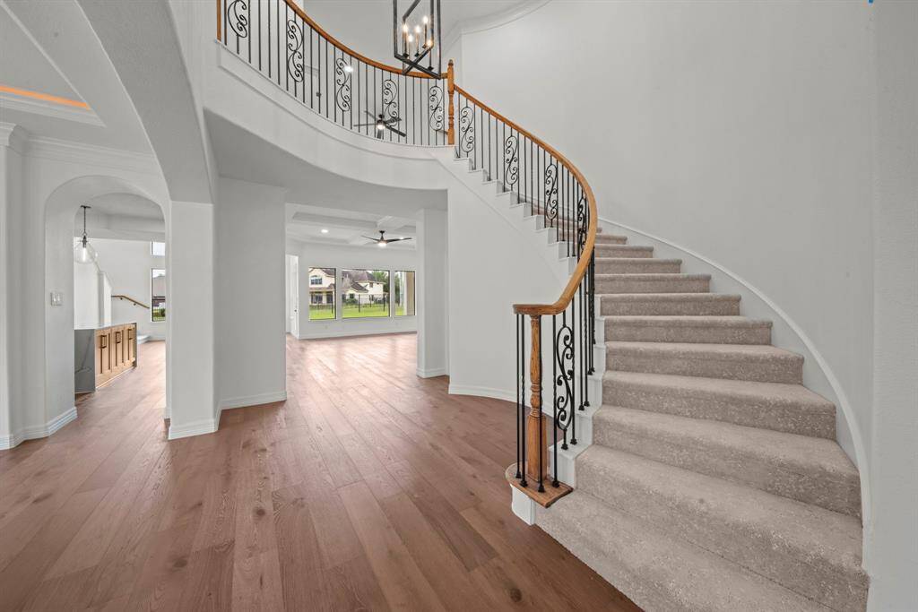 open staircase floats up to the second floor through the grand entry