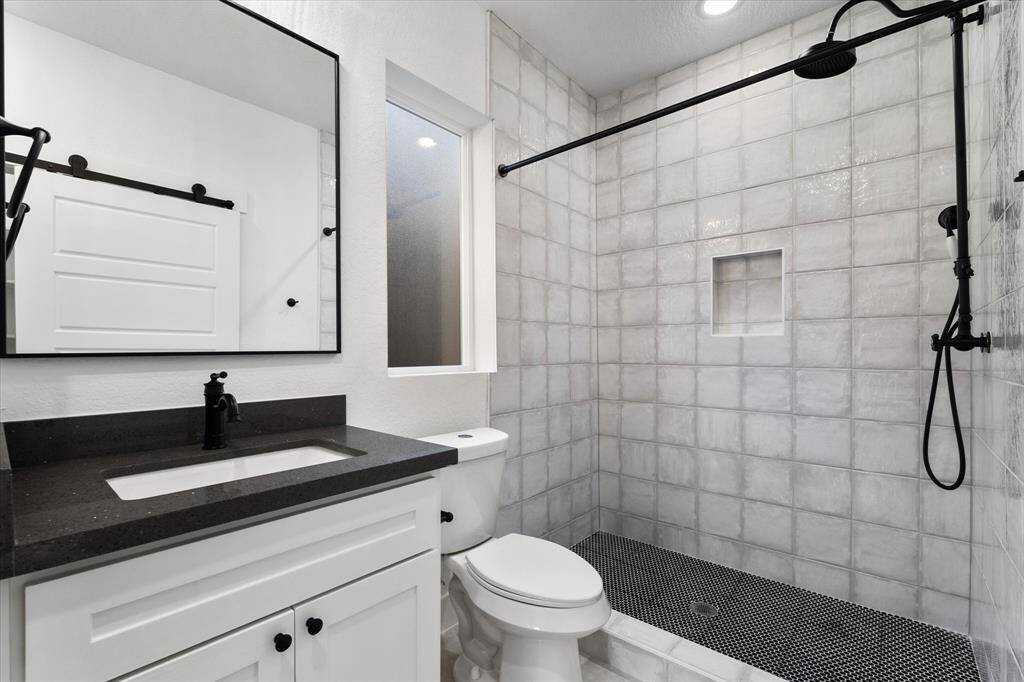 The en suite bathroom features a linen closet and a spacious stand up shower. A frosted glass window adds a soft touch of natural light while maintaining your privacy.