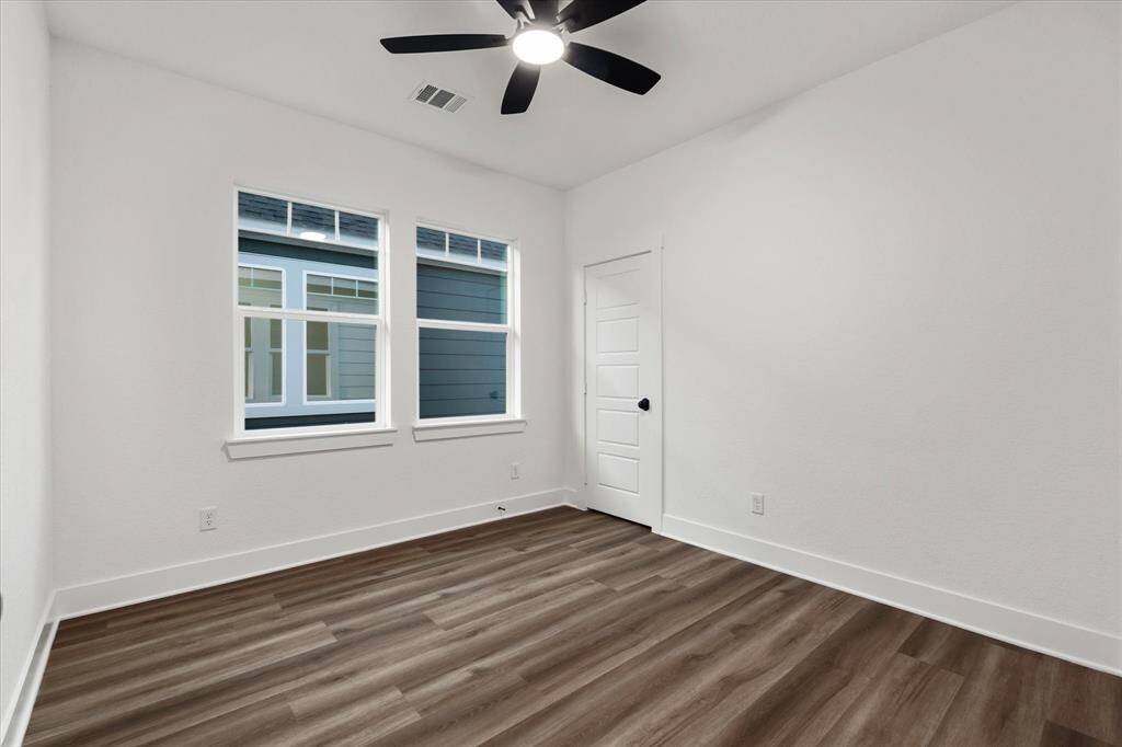 Bedroom two features a ceiling fan, two large windows that let in plenty of natural light, and a spacious closet for all your storage needs.