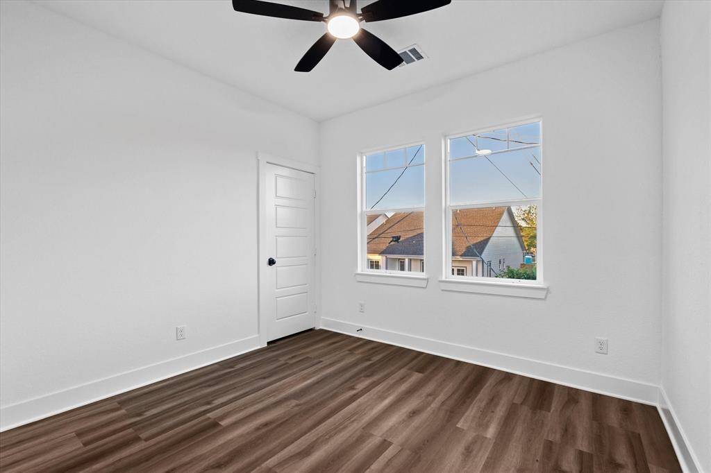 Bedroom 3! Also with no carpet, a ceiling fan, and rear-facing windows.