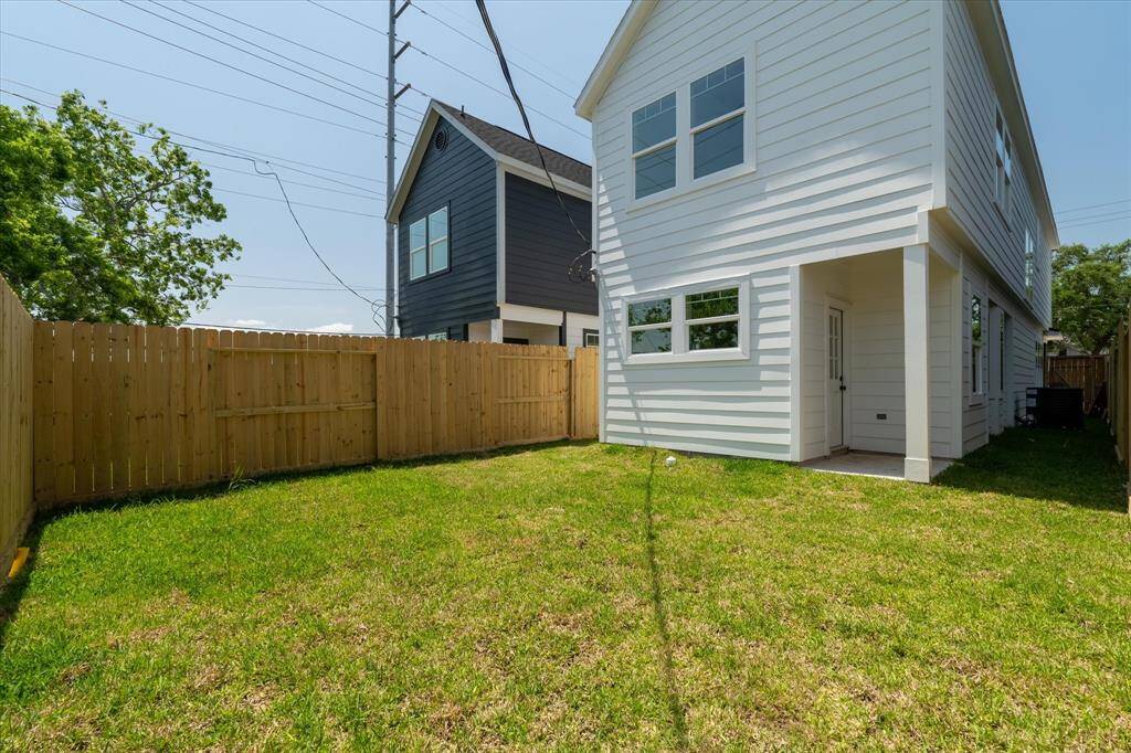 The backyard is fully fenced for privacy and features a covered patio, perfect for outdoor relaxation or entertaining.