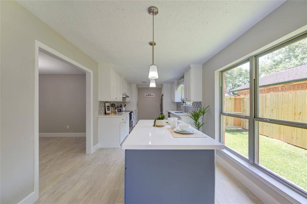 A picture-perfect custom built island features fully functional cabinets for extra storage.